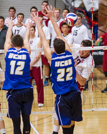 Brian Cook (Stanford) spikes against Jake Staahl and Jonah Seif (UC Santa Barbara)